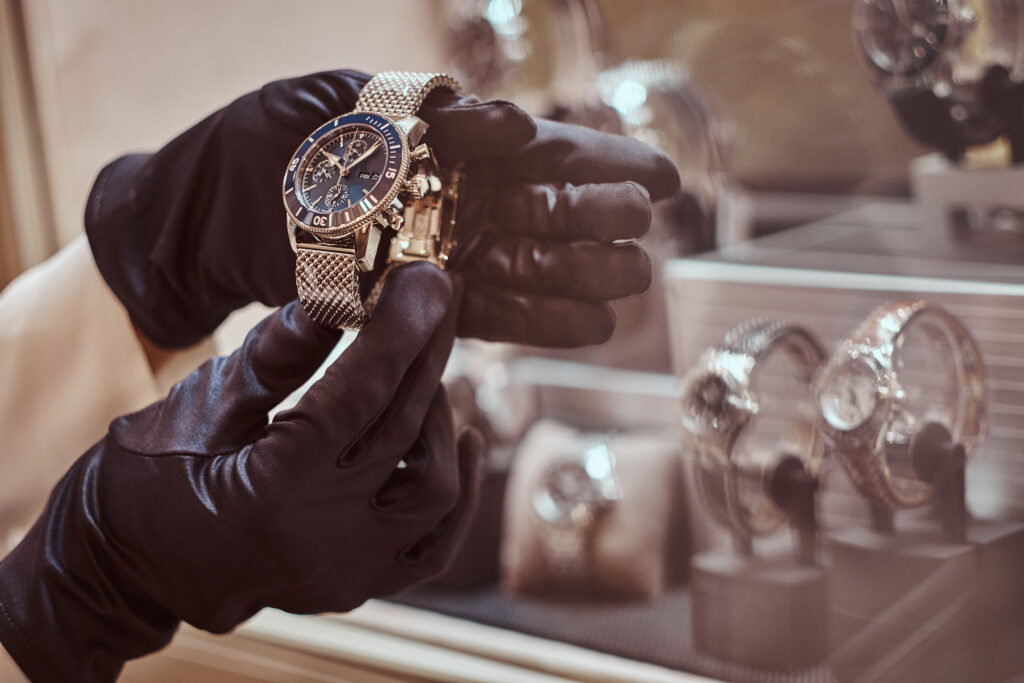 close up of the seller's hands in gloves shows the exclusive men's watch from the new collection